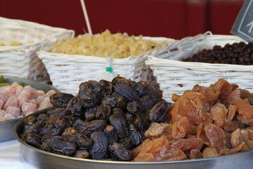 dried fruit lined up in baskets, dates, dried cranberries, apricots, pineapple, dried fruit store