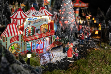 Circus fun house with Christmas lights and toy dolls against a Christmas background in a shop with Christmas items