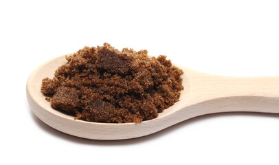 Sugar muscovado in wooden spoon isolated on white background