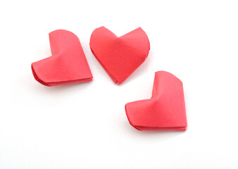 Fototapeta premium three red origmai hearts on white