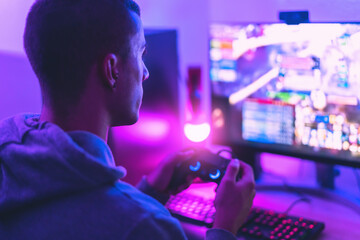 Young gamer playing online video games while streaming on social media - Youth people addicted to new technology game - obrazy, fototapety, plakaty