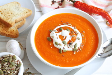 Pumpkin puree soup on white background