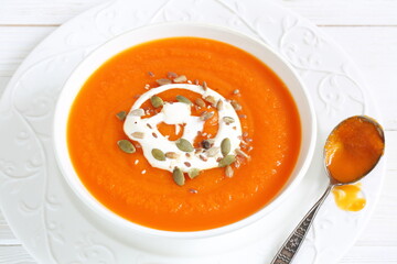 Pumpkin puree soup on white background