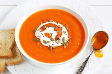 Pumpkin puree soup on white background
