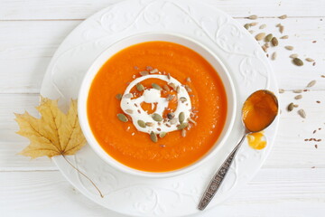 Pumpkin puree soup on white background