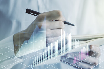 Abstract creative financial graph with hand writing in diary on background, financial and trading concept. Multiexposure