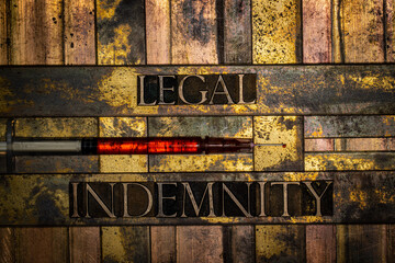 Legal Indemnity text with syringe on textured grunge copper and vintage gold background