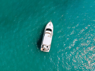 Adorable aerial top view photo of a laxury huge two-storey yach sailing across the deep blue sea