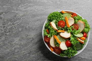 Delicious fresh chicken salad served on grey table, top view. Space for text
