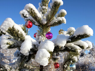 christmas tree with toys in winter forest