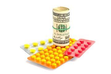 Medicines and dollars isolated on white with shadow. Blister with pills and paper money lying nearby.