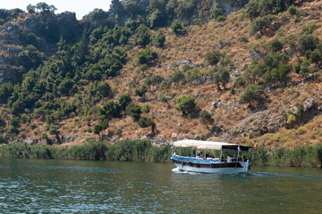 A small boat in a body of water with a mountain in the background
