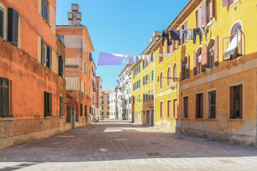 narrow street in Venice, Venezia, Italy,  laundry hung up to dry, sunshine, country customs