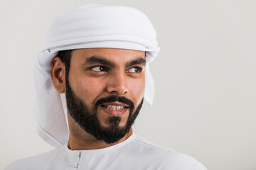 Handsome man with traditional white kandura from uae. Studio portraits with Dubai outfit about fashion and lifestyle