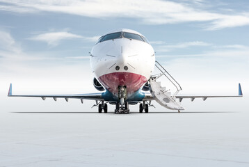 Front view of the modern corporate business jet with open gangway door isolated on bright...