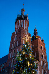 Fototapeta na wymiar Big glowing decorated christmas tree standing in main market square, winter holidays, peoples enjoy.