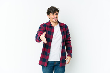 Fototapeta premium Young cool man stretching hand at camera in greeting gesture.