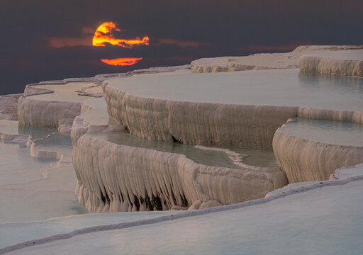 A beautiful sunset over the water-filled pamukkale travertines. Turkey landmark