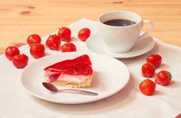 Strawberry cake, coffee and fresh strawberry near on wooden table. Selective focus.