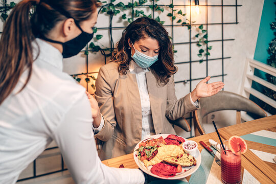 Young Waitress With Face Protective Mask Working In Restaurant. Coronavirus Or Covid-19 Concept.