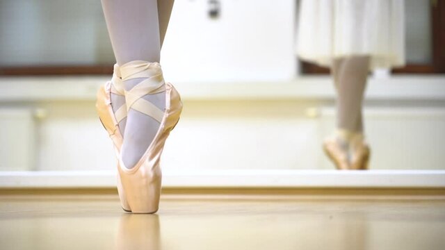 Ballerina Dancing Shoes Close Up On Wooden Floor With Mirror Behind In Slow Motion