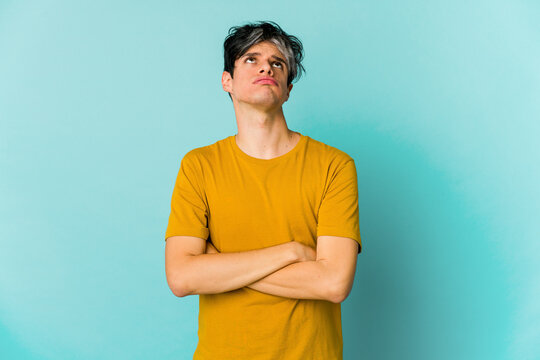 Young caucasian skinny man expressing emotions isolated on blue background