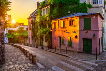Sunset view of cozy strert in quarter Montmartre in Paris, France