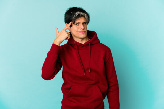 Young caucasian skinny man expressing emotions isolated on blue background
