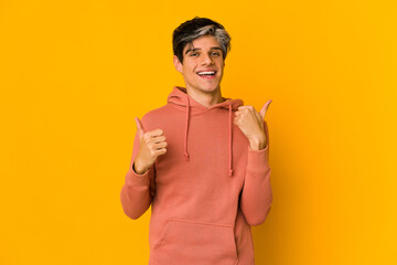 Young skinny hispanic man raising both thumbs up, smiling and confident.