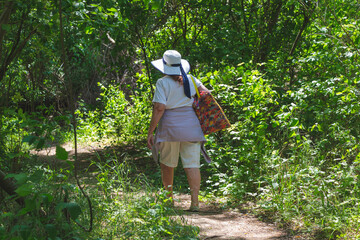 Senior tourist woman on a forest background. Healthy lifestyle.Hiking.