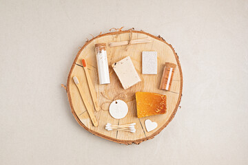 Eco friendly soap bar, tooth brushes, cotton swabs, bath salt, clay mask and washcloth on neutral background. Zero waste sustainable lifestyle