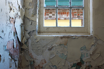 Deteriorating wall with broken window view