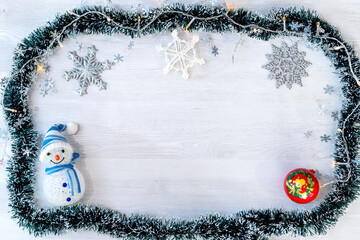 New Year or Christmas holidays decoration with green decorative ribbon, light bulbs, snowflake...