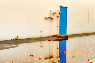 Blue door reflects in flood waters