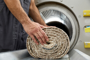 Man operating drying machine for carpet cleaning. Professional carpet cleaning service
