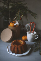 Spruce branch, pastries, toys are on the table.