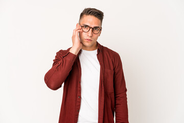 Young caucasian handsome man isolated blows cheeks, has tired expression. Facial expression concept.