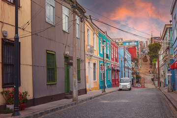 Fototapeta na wymiar Street with colorful facades of old historic buildings in Valparaiso, Chile