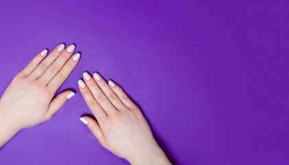 Female manicure on a bright background. Purple