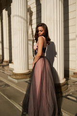 Young beautiful woman in an evening dress in the theater