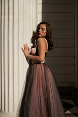 Young beautiful woman in an evening dress in the theater