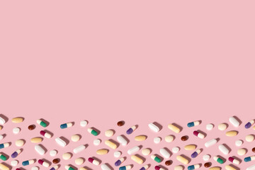 Background made with different pills and medicine on pink