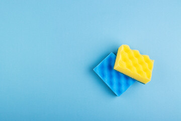colorful sponges and cleaning cloths on a beautiful blue background