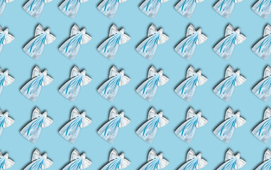 A pattern of medical masks that are made in the shape of Christmas angels. Christmas 2021.