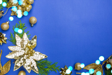 Christmas holidays composition with gold decorations on blue background with copy space for your text