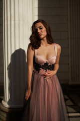Fototapeta premium Young beautiful woman in an evening dress in the theater