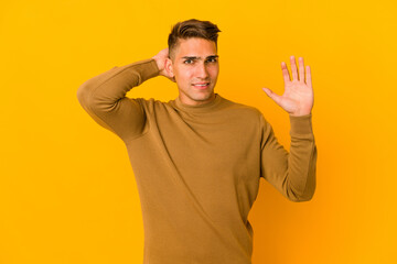 Young handsome caucasian man isolated screaming with rage.