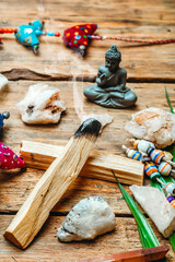 Burning palo santo background with crystals and gemstones. Cleansing bundle with healing minerals and candles. Relax and zen flat lay