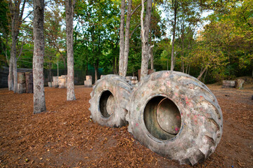 There are a lot of abandoned old and damaged tires at the paintball base