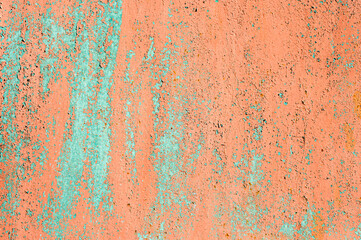Old rusty metal wall with peeling and peeling red and burgundy paint